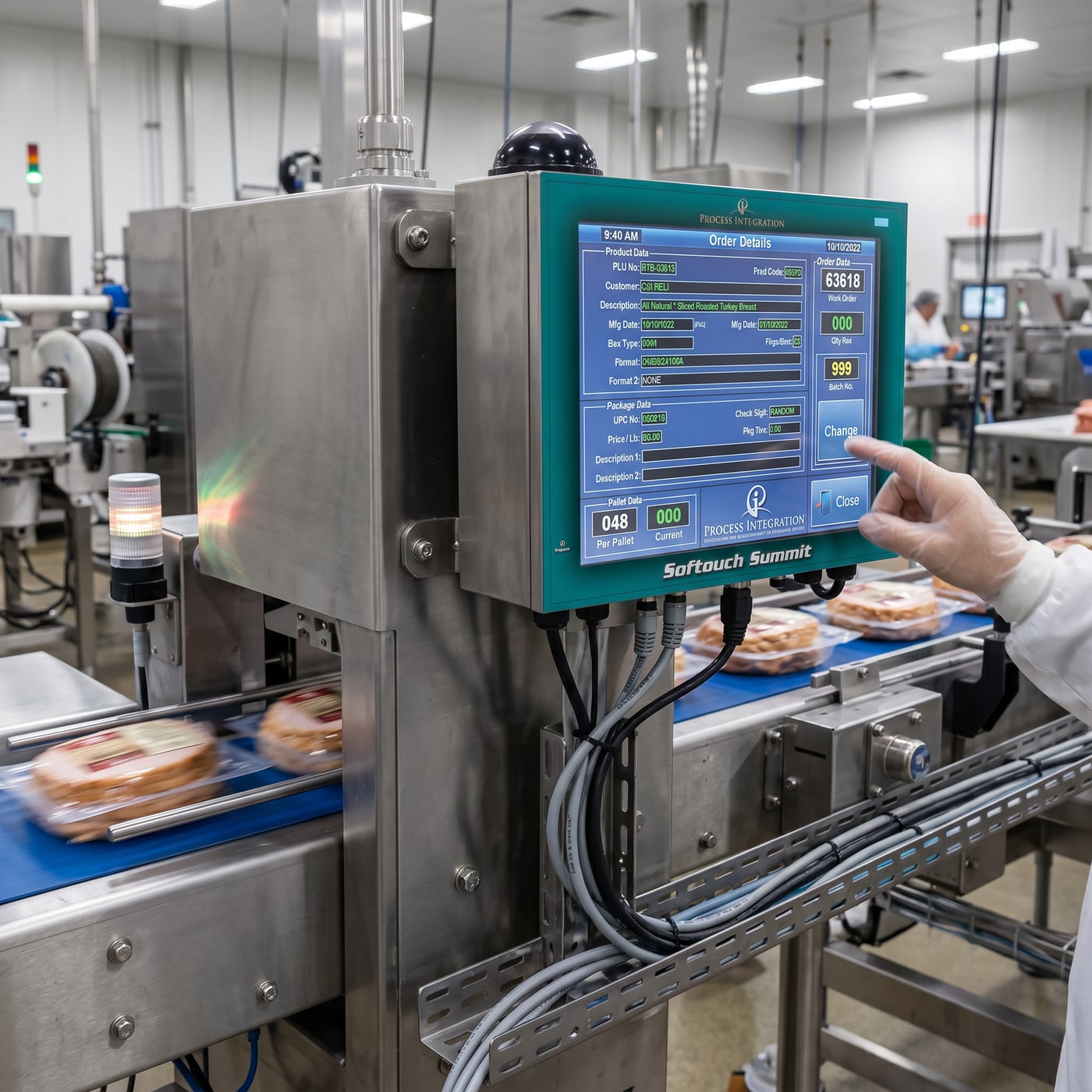 A Softouch Summit mounted beside a packaging line, an operator using the touchscreen